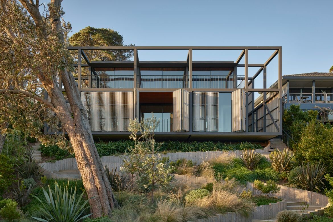 This absolute beachfront home sensitively frames the view